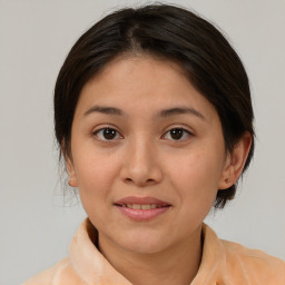 Joyful latino young-adult female with medium  brown hair and brown eyes