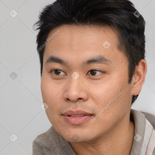 Joyful asian young-adult male with short  black hair and brown eyes