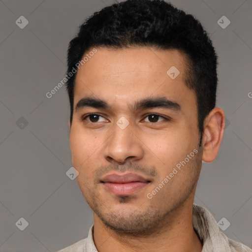 Joyful latino young-adult male with short  black hair and brown eyes