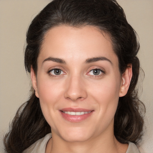 Joyful white young-adult female with medium  brown hair and brown eyes