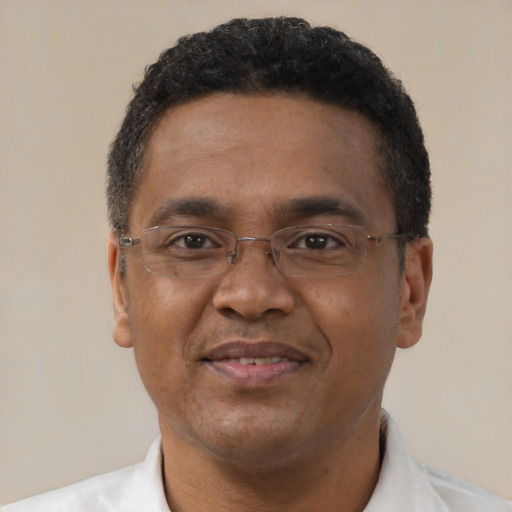Joyful black adult male with short  black hair and brown eyes