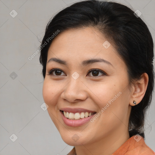 Joyful latino young-adult female with medium  brown hair and brown eyes