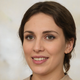 Joyful white young-adult female with medium  brown hair and green eyes