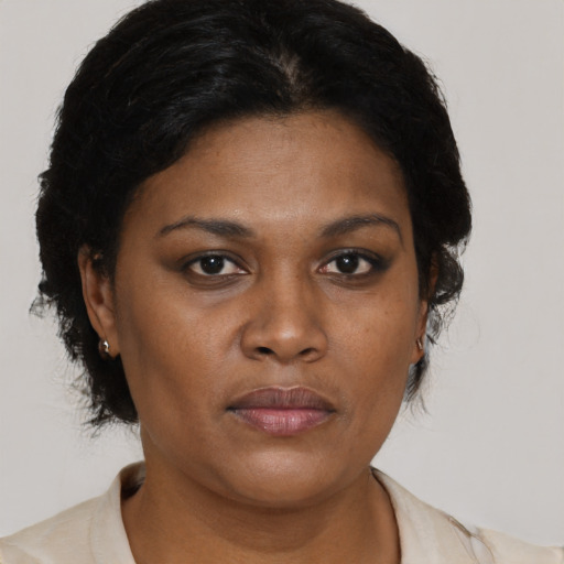 Joyful black adult female with short  brown hair and brown eyes