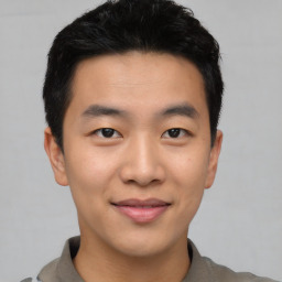 Joyful asian young-adult male with short  black hair and brown eyes