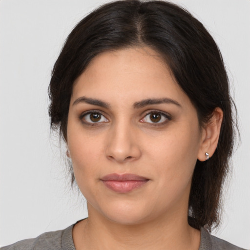 Joyful white young-adult female with medium  brown hair and brown eyes