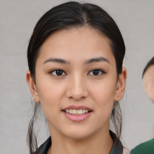 Joyful asian young-adult female with medium  brown hair and brown eyes