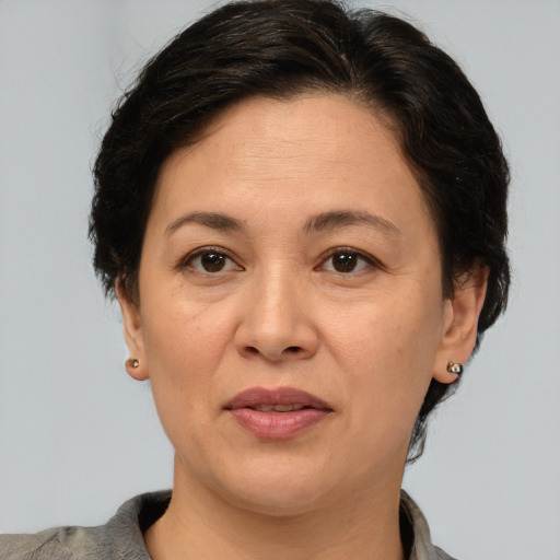 Joyful white adult female with short  brown hair and brown eyes