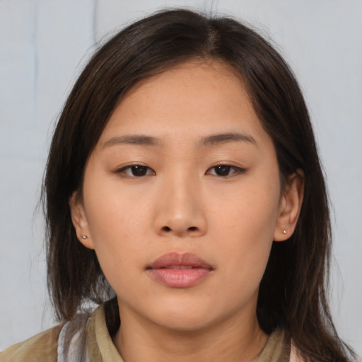Neutral asian young-adult female with medium  brown hair and brown eyes