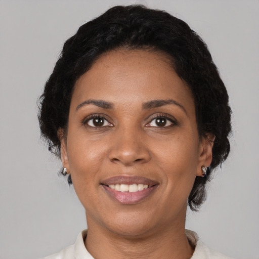 Joyful black young-adult female with medium  black hair and brown eyes