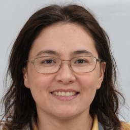 Joyful white adult female with long  brown hair and brown eyes