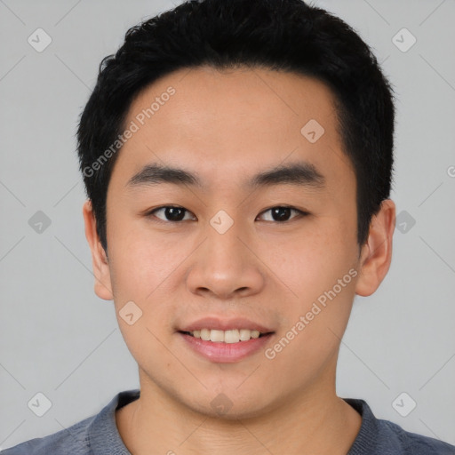 Joyful asian young-adult male with short  black hair and brown eyes