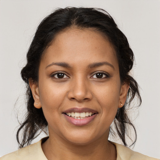 Joyful latino young-adult female with medium  brown hair and brown eyes