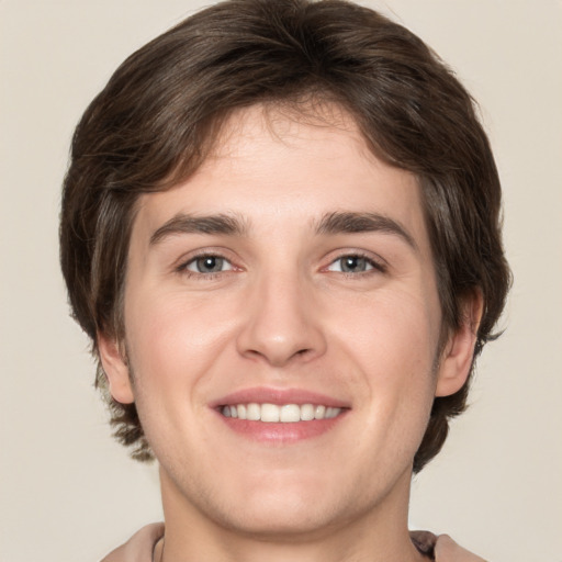 Joyful white young-adult male with medium  brown hair and brown eyes