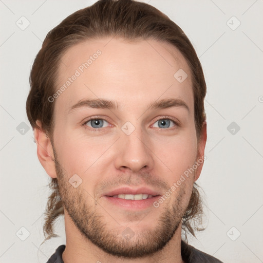 Joyful white young-adult male with short  brown hair and grey eyes