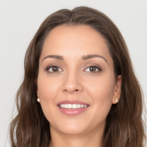 Joyful white young-adult female with long  brown hair and brown eyes