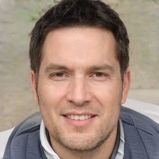 Joyful white adult male with short  brown hair and brown eyes