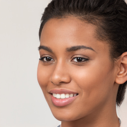 Joyful latino young-adult female with long  brown hair and brown eyes