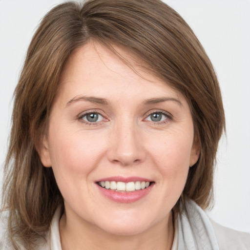 Joyful white young-adult female with medium  brown hair and brown eyes