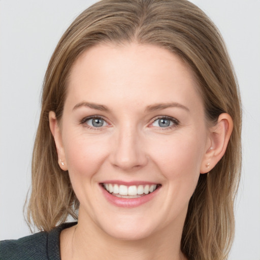 Joyful white young-adult female with medium  brown hair and blue eyes