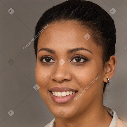 Joyful black young-adult female with short  black hair and brown eyes