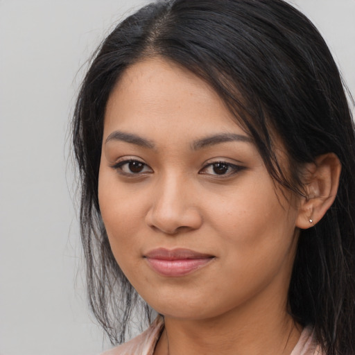 Joyful latino young-adult female with long  black hair and brown eyes