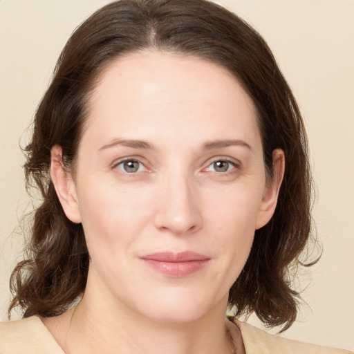 Joyful white young-adult female with medium  brown hair and green eyes