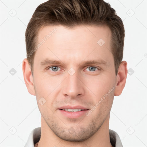 Joyful white young-adult male with short  brown hair and grey eyes