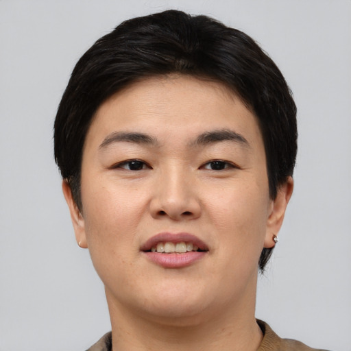 Joyful asian young-adult female with short  brown hair and brown eyes