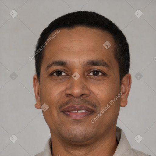 Joyful latino adult male with short  black hair and brown eyes