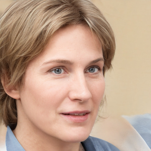 Joyful white young-adult female with medium  brown hair and blue eyes