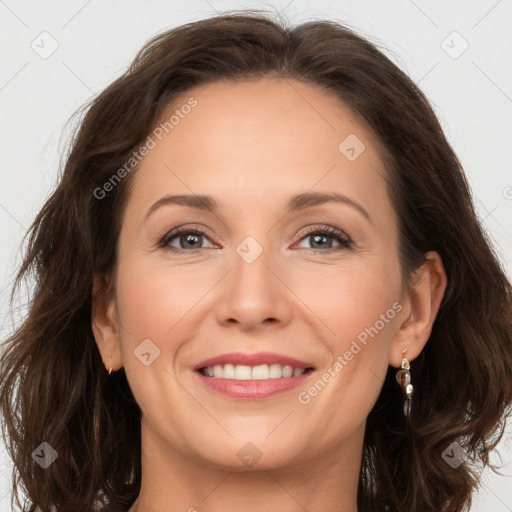 Joyful white adult female with long  brown hair and brown eyes