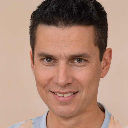 Joyful white adult male with short  brown hair and brown eyes