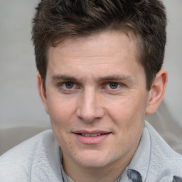 Joyful white adult male with short  brown hair and grey eyes