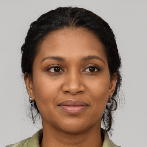 Joyful black young-adult female with medium  black hair and brown eyes