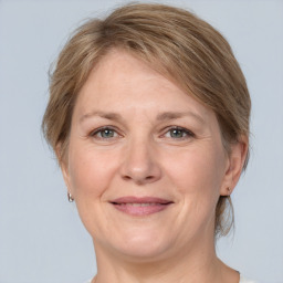 Joyful white adult female with medium  brown hair and grey eyes