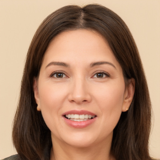 Joyful white young-adult female with long  brown hair and brown eyes