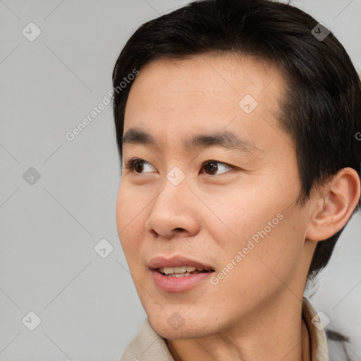 Joyful asian young-adult male with short  brown hair and brown eyes