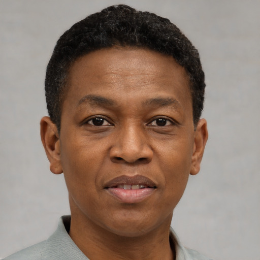 Joyful black adult male with short  brown hair and brown eyes
