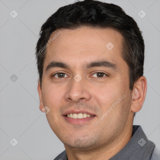 Joyful white young-adult male with short  black hair and brown eyes