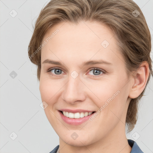 Joyful white young-adult female with medium  brown hair and blue eyes