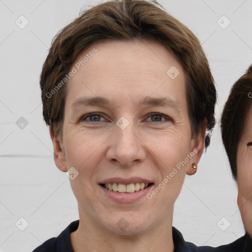 Joyful white adult male with short  brown hair and grey eyes