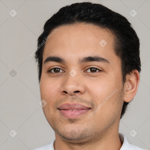 Joyful latino young-adult male with short  black hair and brown eyes