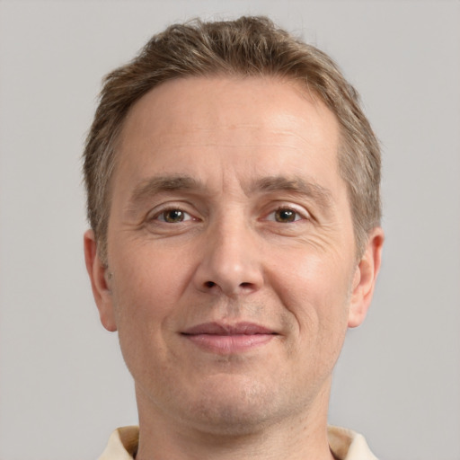 Joyful white adult male with short  brown hair and grey eyes