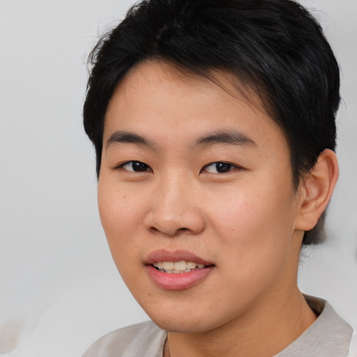 Joyful asian young-adult male with short  brown hair and brown eyes
