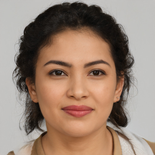 Joyful latino young-adult female with medium  brown hair and brown eyes