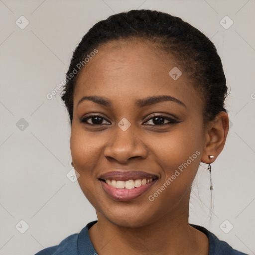 Joyful black young-adult female with long  black hair and brown eyes