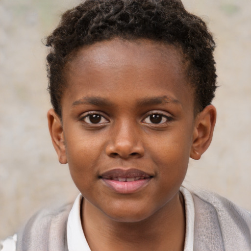 Joyful black child male with short  brown hair and brown eyes