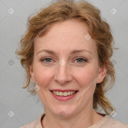 Joyful white adult female with medium  brown hair and blue eyes