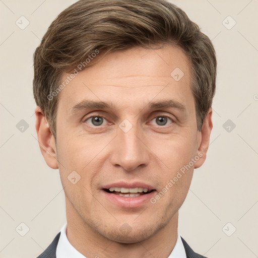 Joyful white adult male with short  brown hair and grey eyes